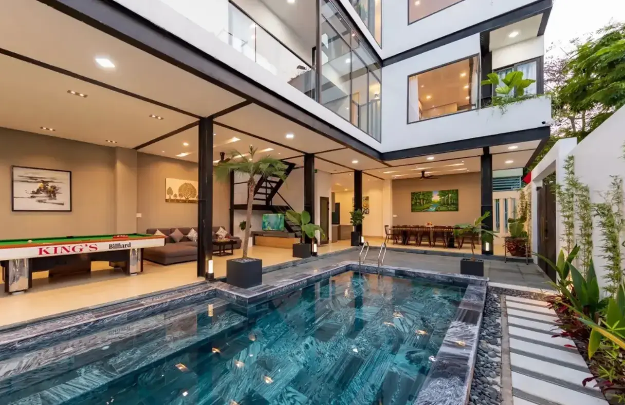 Luxury private pool villa in Da Nang's Ngu Hanh Son area, featuring a lush garden and modern outdoor lounge area.